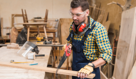 close-up-handyman-sawing-long-wooden-plank 2